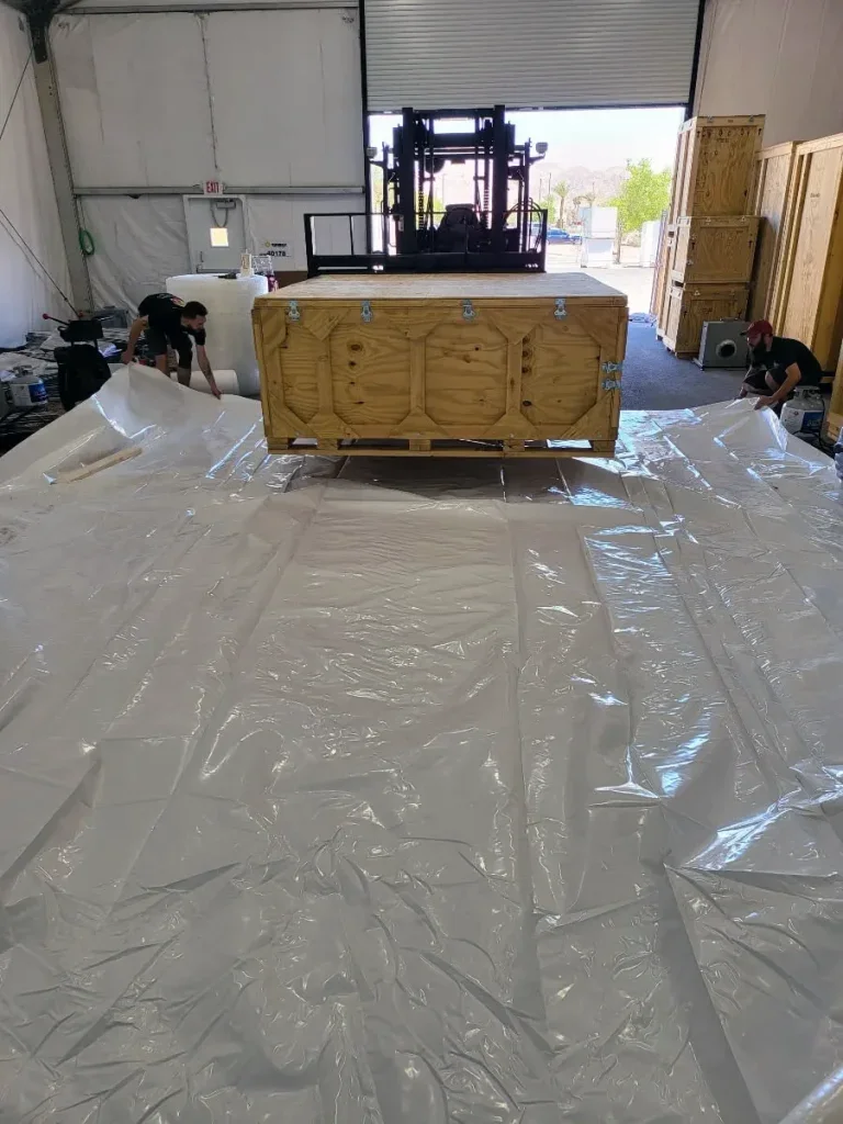 A custom wooden crate being built on site