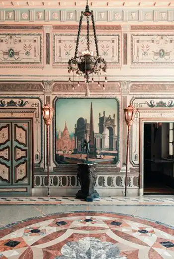 Elegant historic room with fine art paintings and antique decor